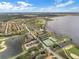Expansive aerial view of a community showcasing lush landscaping, a lake, and various recreational facilities at 1394 Oakmont Dr, Winter Haven, FL 33884