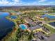 Aerial view of community featuring golf, water features, pools, and clubhouse at 1394 Oakmont Dr, Winter Haven, FL 33884