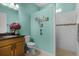 Charming bathroom with granite countertop, tiled shower, and decorative turtle art at 1394 Oakmont Dr, Winter Haven, FL 33884