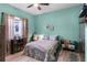 Cozy bedroom with a patterned quilt, wood floors, natural light, and tasteful decorations at 1394 Oakmont Dr, Winter Haven, FL 33884