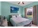 Bedroom featuring a wooden bed frame, modern ocean art, and light-filtering curtains at 1394 Oakmont Dr, Winter Haven, FL 33884
