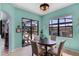 Bright breakfast nook features a round table, four chairs, and sliding glass doors to the lanai at 1394 Oakmont Dr, Winter Haven, FL 33884