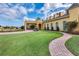 Well-manicured landscaping surrounds a luxury clubhouse featuring beautiful architecture and golf cart parking at 1394 Oakmont Dr, Winter Haven, FL 33884