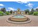 Inviting community entrance with a fountain and the 'Lake Ashton' sign, surrounded by lush landscaping at 1394 Oakmont Dr, Winter Haven, FL 33884