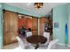 Cozy dining area with modern light fixtures and a barn door leading to an office space at 1394 Oakmont Dr, Winter Haven, FL 33884