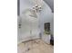 Grand foyer featuring a chandelier, tiled floors, and a decorative console table at 1394 Oakmont Dr, Winter Haven, FL 33884