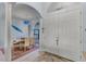 Elegant foyer view with a decorative table, columns, arched openings and double door entry at 1394 Oakmont Dr, Winter Haven, FL 33884