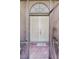 Beige double-door entry with transom window and 'Welcome' mat, seen through an open screen door at 1394 Oakmont Dr, Winter Haven, FL 33884