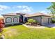 Charming single-story home features a lush lawn, meticulous landscaping, and a three car garage at 1394 Oakmont Dr, Winter Haven, FL 33884
