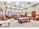 Well-lit game room featuring pool tables, comfortable seating, and a cozy atmosphere for entertainment at 1394 Oakmont Dr, Winter Haven, FL 33884