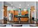 Beautiful kitchen featuring a breakfast bar with stylish pendant lighting and stainless steel appliances at 1394 Oakmont Dr, Winter Haven, FL 33884