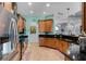 Well-lit kitchen with stainless steel appliances, granite countertops, and wood cabinetry at 1394 Oakmont Dr, Winter Haven, FL 33884