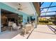 Spacious screened-in lanai with ample seating, ceiling fans, and a seamless transition to indoor living spaces at 1394 Oakmont Dr, Winter Haven, FL 33884