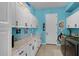 Well-appointed laundry room with ample white cabinets, granite countertop, and modern washer and dryer at 1394 Oakmont Dr, Winter Haven, FL 33884