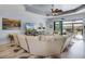 Bright living room with tray ceilings, a ceiling fan, and sliding glass doors to the patio at 1394 Oakmont Dr, Winter Haven, FL 33884