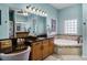 Inviting main bathroom with a large vanity, granite countertop, soaking tub, and decorative finishes at 1394 Oakmont Dr, Winter Haven, FL 33884