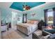 Light-filled main bedroom boasts tray ceiling, ceiling fan, accent lighting, and an ensuite bathroom at 1394 Oakmont Dr, Winter Haven, FL 33884