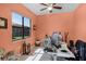 Bright home office with an adjustable desk, large window, and natural light at 1394 Oakmont Dr, Winter Haven, FL 33884