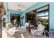 Relaxing patio features comfortable seating, a ceiling fan, and view of the kitchen through the sliding glass door at 1394 Oakmont Dr, Winter Haven, FL 33884