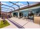 Spacious screened-in patio boasts a hot tub, ceiling fans, grill, and plenty of room for entertaining at 1394 Oakmont Dr, Winter Haven, FL 33884