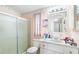 Functional bathroom featuring a glass-enclosed shower, toilet, and vanity with ample counter space at 145 Jana Cir, Auburndale, FL 33823