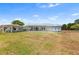 Community clubhouse featuring a covered area with metal roof and picnic tables on a grassy lawn at 145 Jana Cir, Auburndale, FL 33823