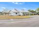 Community clubhouse features a metal roof, American flag, and convenient parking at 145 Jana Cir, Auburndale, FL 33823