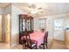 Inviting dining area with wood table, china cabinet, window, and access to adjacent rooms at 145 Jana Cir, Auburndale, FL 33823