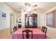Bright dining area features a wood table with pink tablecloth, chair set, and a china cabinet at 145 Jana Cir, Auburndale, FL 33823