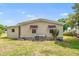 Beige siding with window awnings of a single story home on a sunny day with green lawn at 145 Jana Cir, Auburndale, FL 33823