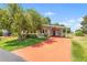 Charming one-story home with a carport and beautifully landscaped front yard at 145 Jana Cir, Auburndale, FL 33823