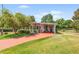 Inviting single-story home featuring a charming carport and well-maintained lawn at 145 Jana Cir, Auburndale, FL 33823