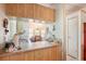 Practical kitchen featuring a breakfast bar with a pass-through window and storage at 145 Jana Cir, Auburndale, FL 33823