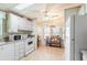Bright kitchen with a ceiling fan, microwave, oven, and convenient storage shelves at 145 Jana Cir, Auburndale, FL 33823