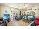 Inviting living room with wood-look flooring, comfortable seating, and bright natural light at 145 Jana Cir, Auburndale, FL 33823