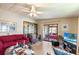Cozy living room with ceiling fan and sliding doors to an enclosed porch, decorated with unique accents at 145 Jana Cir, Auburndale, FL 33823