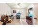 Comfortable living room with wood-look floors, a ceiling fan, and a television setup at 145 Jana Cir, Auburndale, FL 33823