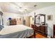 Bright main bedroom featuring a wooden dresser, and view of the bathroom and closet at 145 Jana Cir, Auburndale, FL 33823