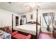 Spacious bedroom with four-poster bed, walk-in closet, and warm hardwood floors at 145 Jana Cir, Auburndale, FL 33823
