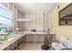Bright utility room with counter space, storage shelves, and natural light from the window at 145 Jana Cir, Auburndale, FL 33823