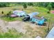 Aerial view of property showcasing houses, storage, carports and multiple outbuildings at 14810 Brahma Rd, Polk City, FL 33868