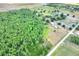 High angle aerial view of the lot and its mature trees next to a paved road at 14810 Brahma Rd, Polk City, FL 33868