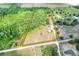 Aerial view of a property with a yellow outline highlighting the land, featuring a mix of trees and open fields at 14810 Brahma Rd, Polk City, FL 33868