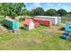 Aerial view featuring multiple storage units, sheds, and lush green landscape on the property at 14810 Brahma Rd, Polk City, FL 33868