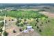 Expansive aerial view of the wooded lot with a tranquil pond and outbuildings enhancing the property's rural charm at 14810 Brahma Rd, Polk City, FL 33868