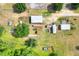Aerial view of the expansive property showcasing multiple structures and lush greenery at 14810 Brahma Rd, Polk City, FL 33868