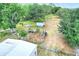 Aerial view revealing large property with sheds, pastures, and diverse foliage at 14810 Brahma Rd, Polk City, FL 33868