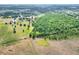 Beautiful aerial view of the property's pasture and wooded areas at 14810 Brahma Rd, Polk City, FL 33868