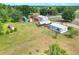 Sprawling property with a mobile home, outbuildings, carports, and extensive green space at 14810 Brahma Rd, Polk City, FL 33868