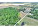 Scenic aerial view of the lot with a wooded area and homes nearby, blending nature with comfortable living at 14810 Brahma Rd, Polk City, FL 33868